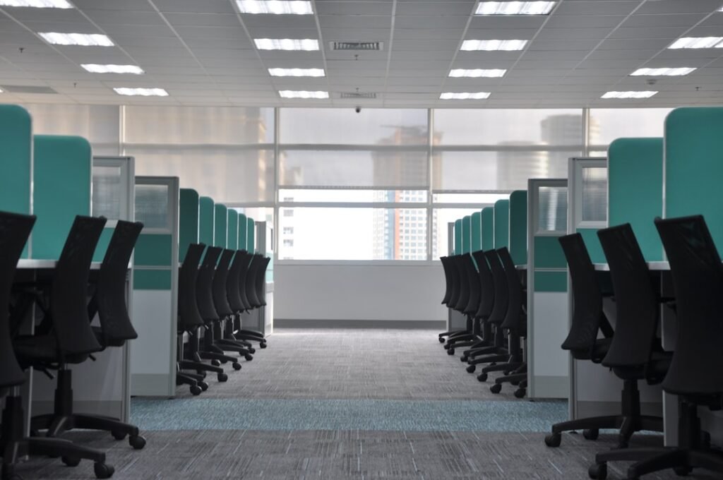 background job queues — empty black rolling chairs at cubicles