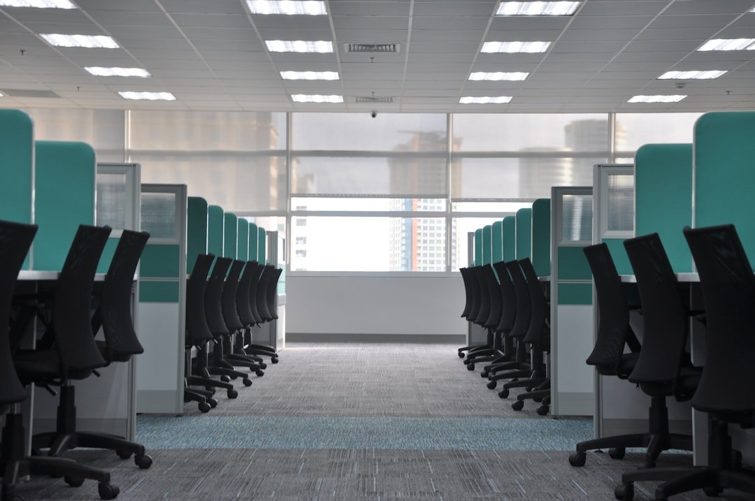 background job queues — empty black rolling chairs at cubicles
