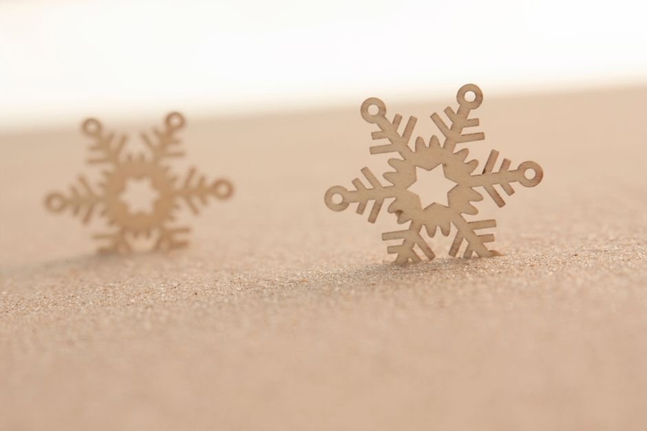 data warehouse comparison — Wooden snowflake decorations placed on a sandy surface under soft light. Perfect for winter themes.