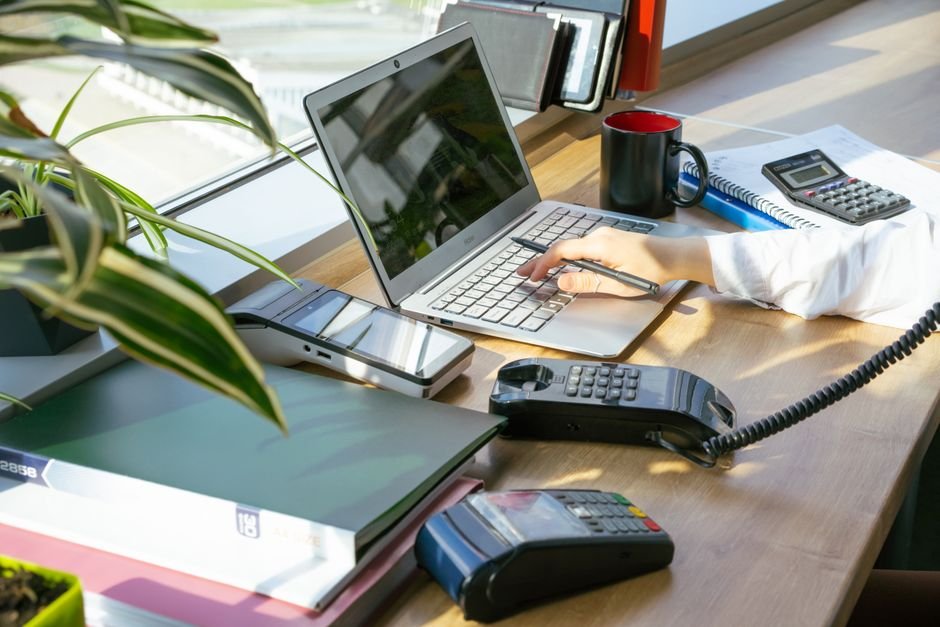 A bright modern office desk setup with electronic devices and plants, ideal for productivity.