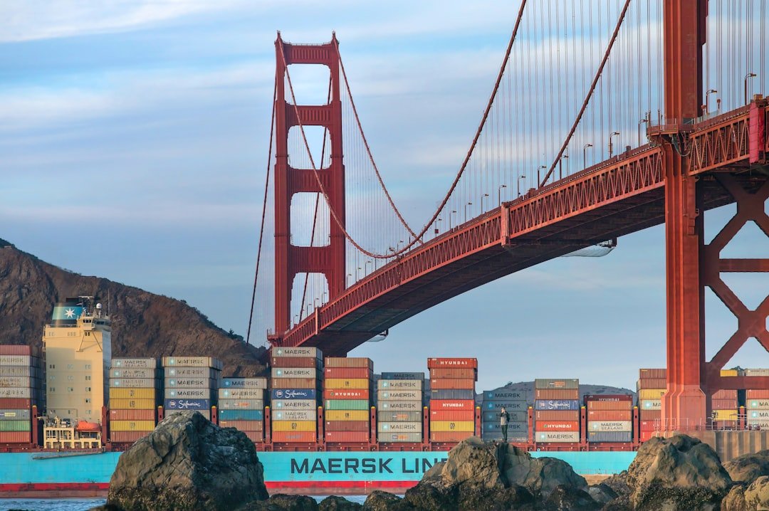 Cargo ship passes under golden gate bridge